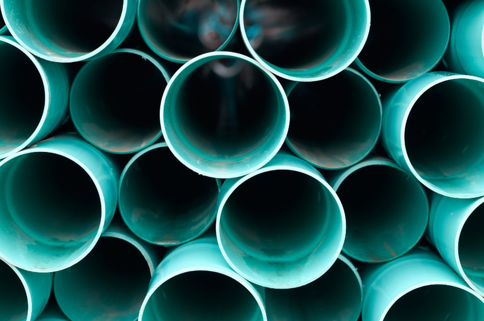 Stack of new teal plumbing pipes