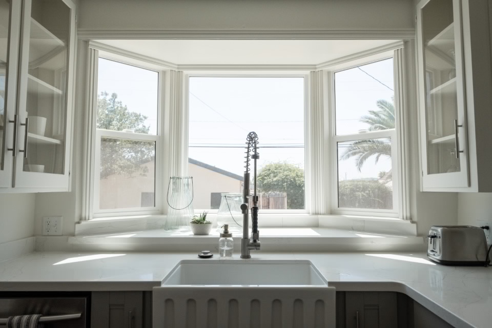 Farmhouse sink under a bay window